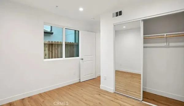 an empty room with wooden floor