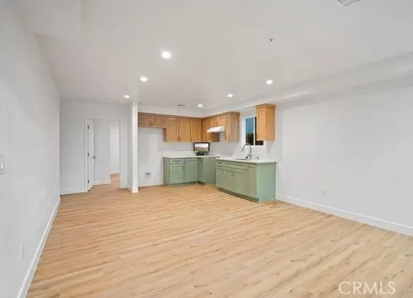 a view of a kitchen with a sink and cabinets