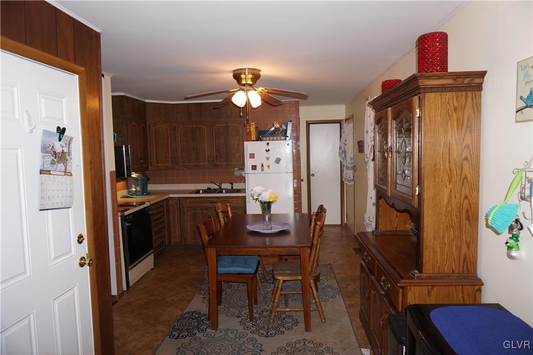 1985 Bathgate Road Bethlehem, PA 18018 - Photo 20 of 22 a kitchen with stainless steel appliances kitchen island granite countertop a refrigerator a stove and a dining table with wooden floor