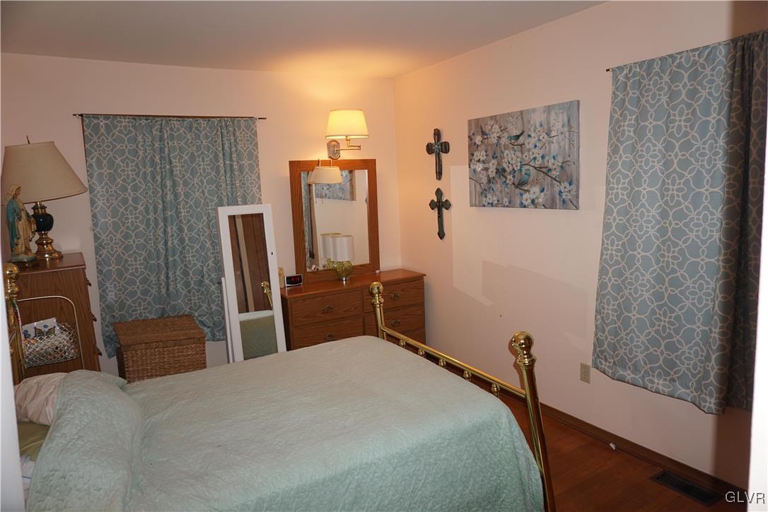 1985 Bathgate Road Bethlehem, PA 18018 - Photo 7 of 22 a bedroom with a bed and a flat tv screen on the dresser