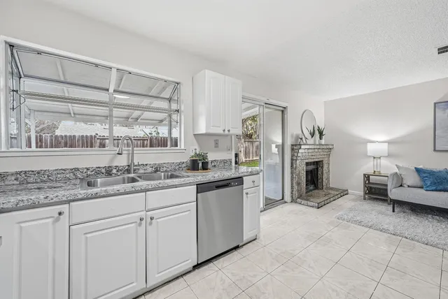 a kitchen with stainless steel appliances kitchen island granite countertop a sink and cabinets