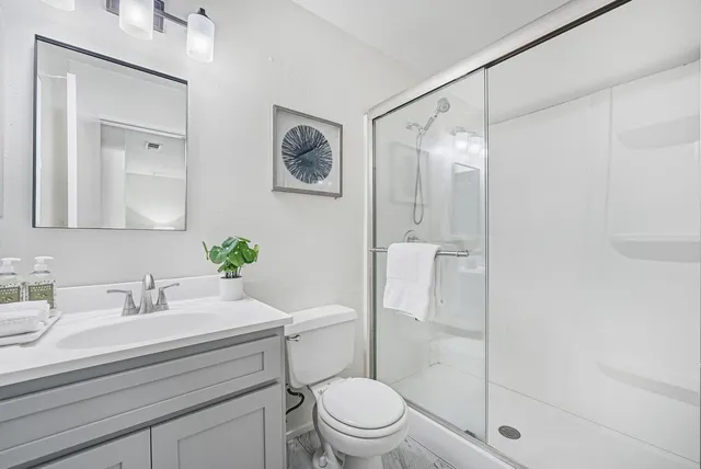 a bathroom with a sink toilet and shower