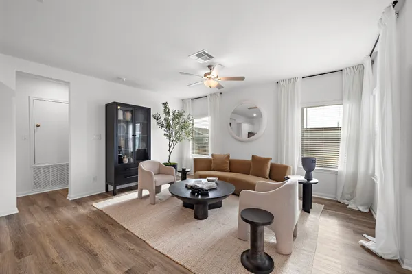 a living room with fireplace furniture and a large window