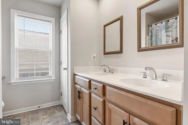 a bathroom with a tub sink and mirror
