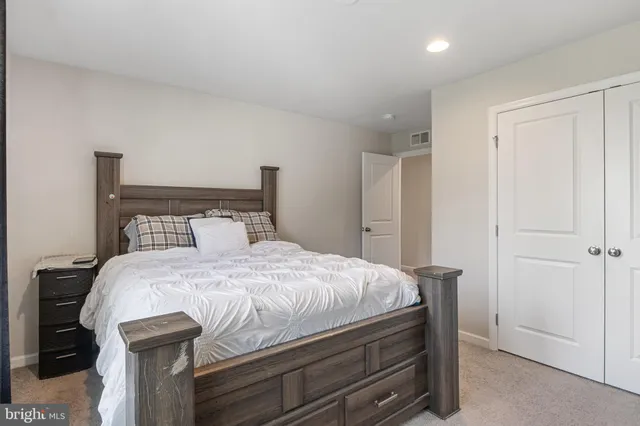 a spacious bedroom with a bed and window