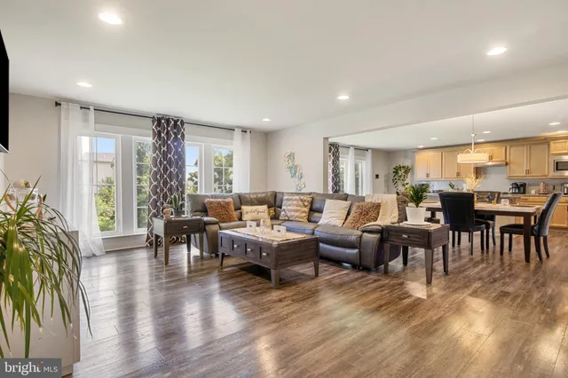 a living room with lots of furniture and a large window