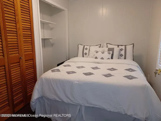 a bedroom with a bed and a night stand