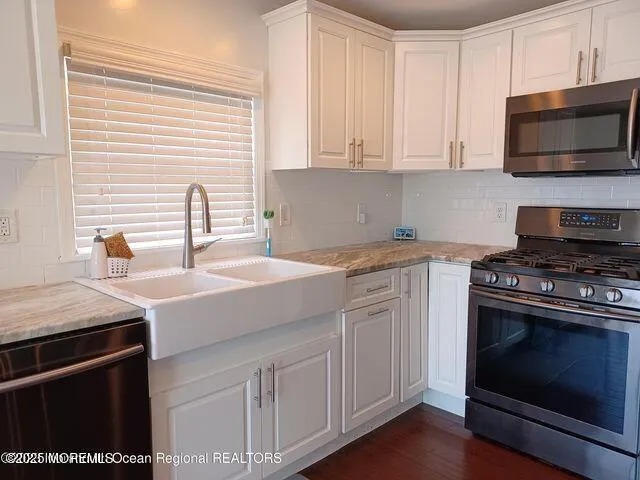 a kitchen with a sink stove and microwave