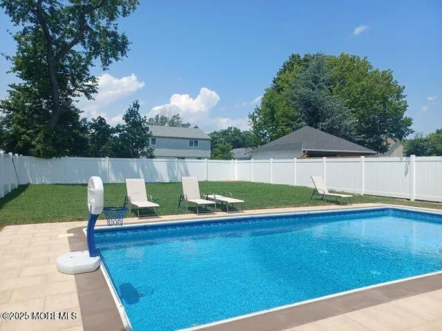 a view of a backyard with swimming pool