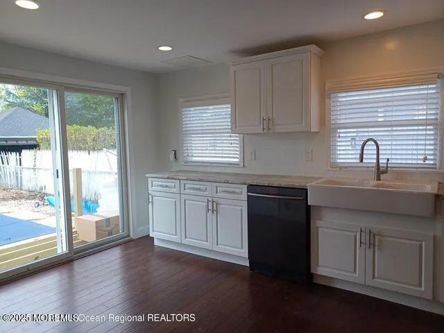 a kitchen with a sink stove and cabinets