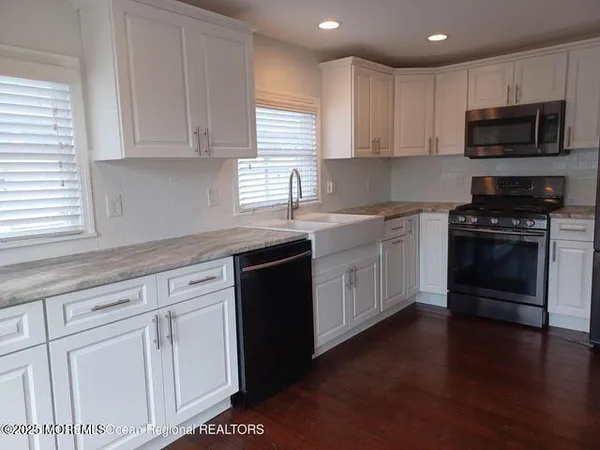 a kitchen with sink cabinets and stainless steel appliances