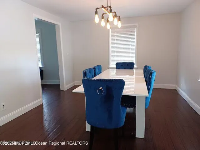 a view of a dining room with furniture wooden floor and chandelier