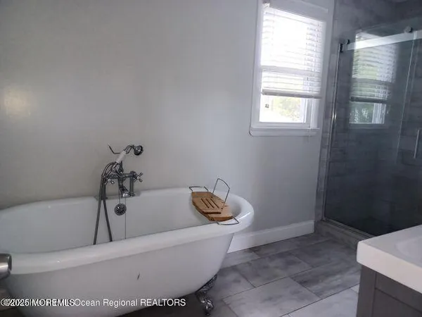 a bathroom with a bathtub and window