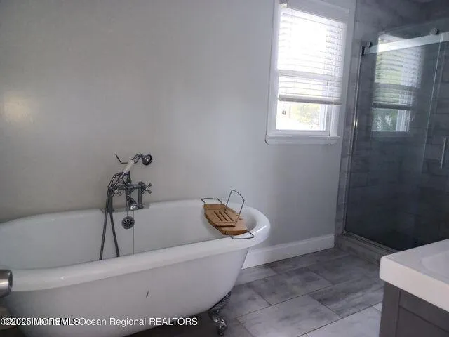 a bathroom with a bathtub and window