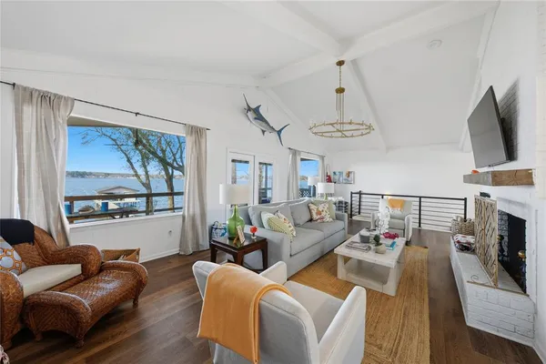 a living room with furniture a flat screen tv and a large window