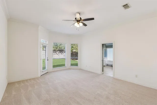 an empty room with closet and windows