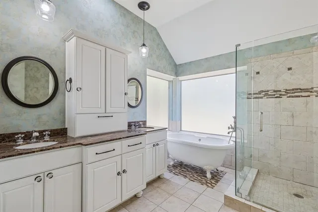 a bathroom with a granite countertop sink a toilet and shower