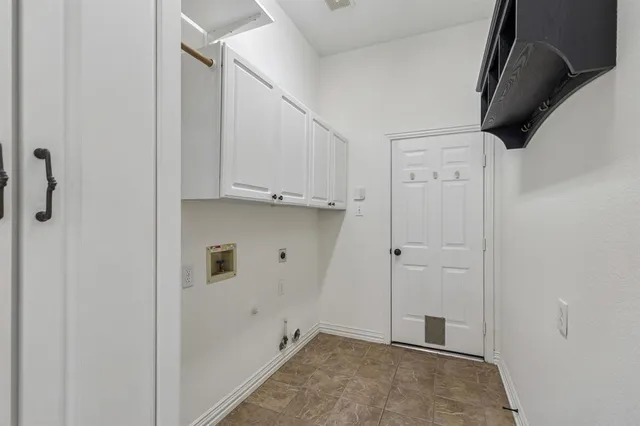 an empty room with fireplace and windows