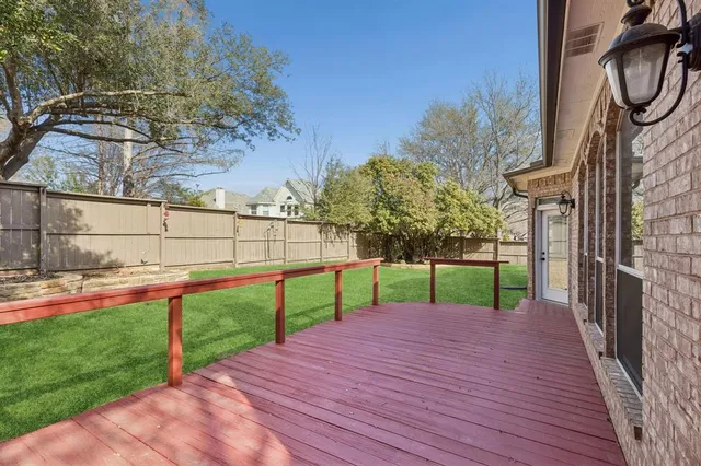 a view of a backyard with wooden fence