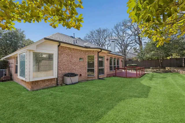 a view of a house with a yard and sitting area