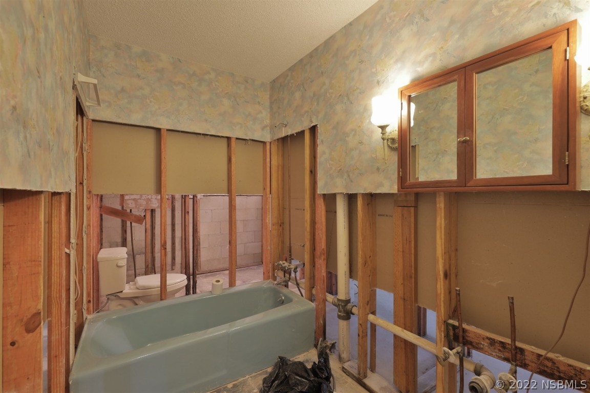1701 Orange Tree Drive Edgewater, FL 32132 - Photo 16 of 21 a bathroom with a bathtub and a shower
