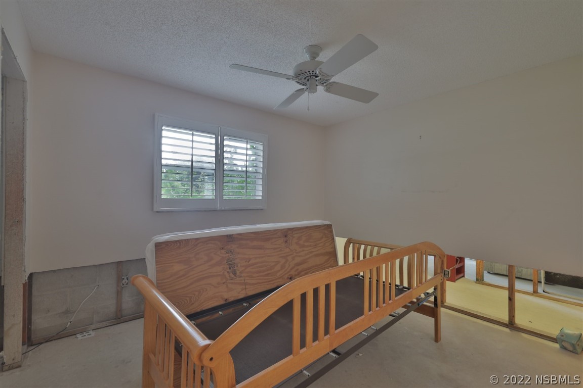 1701 Orange Tree Drive Edgewater, FL 32132 - Photo 17 of 21 a bedroom with furniture and a window