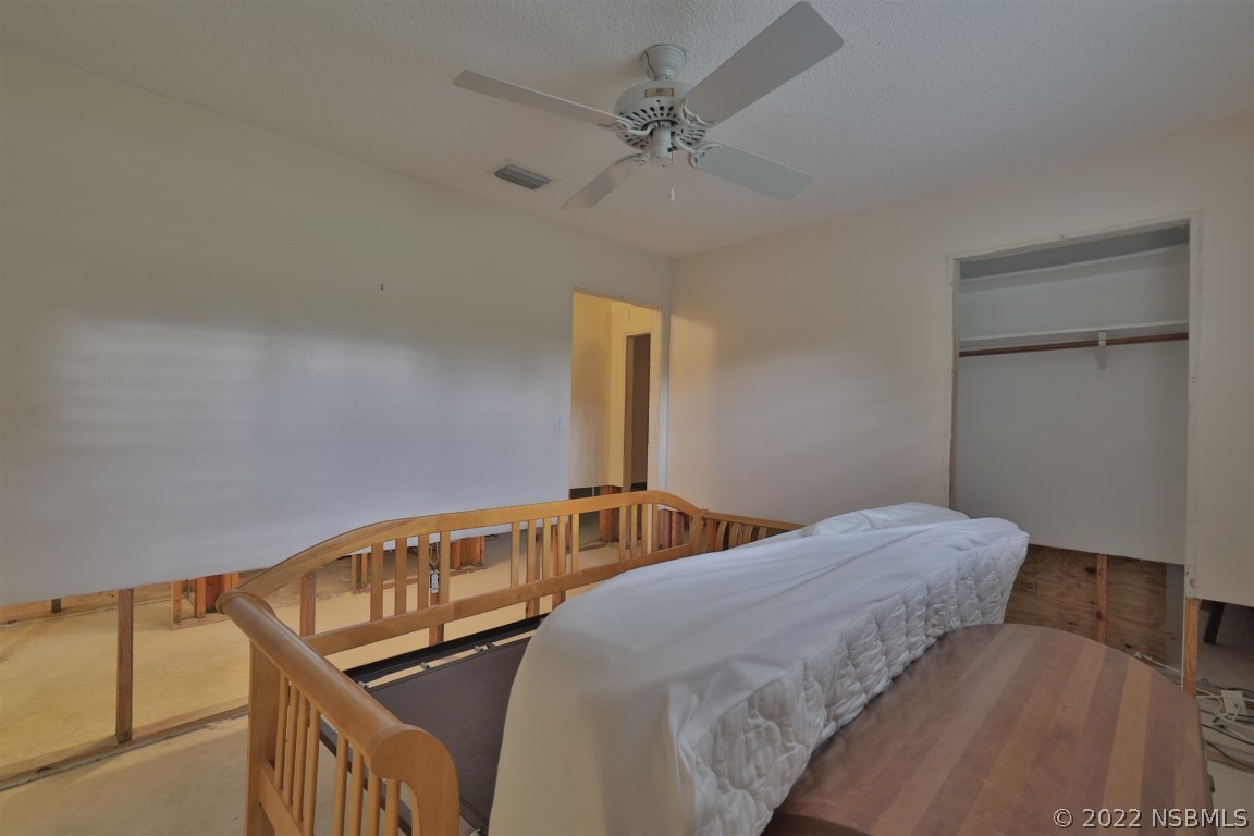 1701 Orange Tree Drive Edgewater, FL 32132 - Photo 18 of 21 a bedroom with two beds and a chandelier