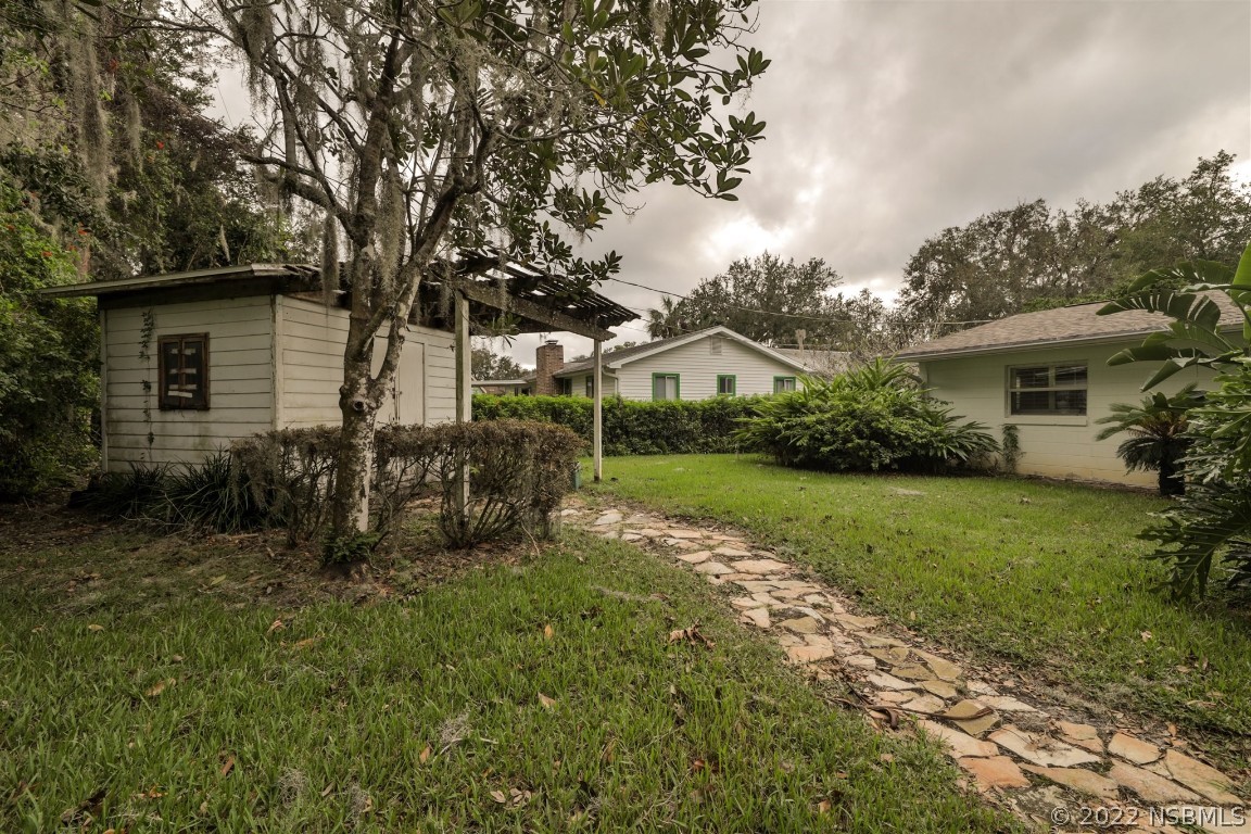 1701 Orange Tree Drive Edgewater, FL 32132 - Photo 20 of 21 a view of backyard of house with green space