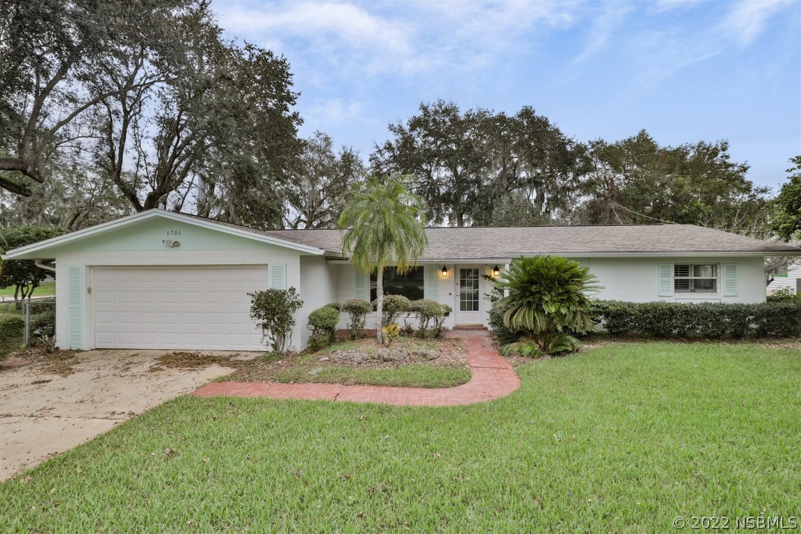 1701 Orange Tree Drive Edgewater, FL 32132 - Photo 2 of 21 a view of house with outdoor space and garden