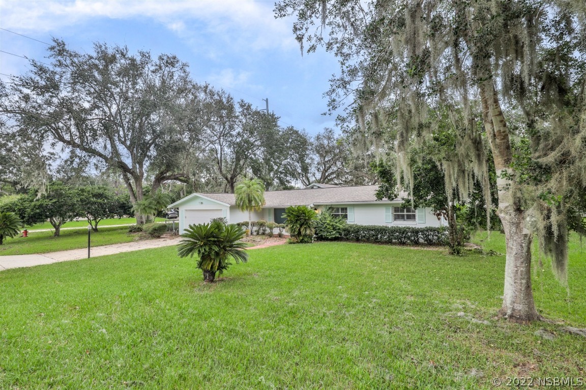 1701 Orange Tree Drive Edgewater, FL 32132 - Photo 4 of 21 a view of a house with a yard porch and sitting area