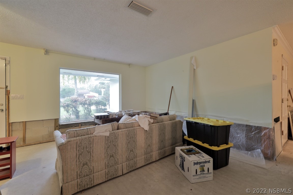 1701 Orange Tree Drive Edgewater, FL 32132 - Photo 6 of 21 a living room with furniture a bed and a window