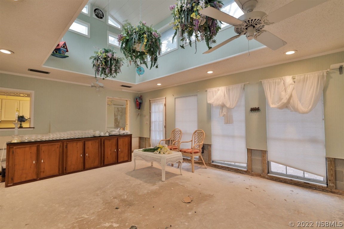 1701 Orange Tree Drive Edgewater, FL 32132 - Photo 9 of 21 a large white bedroom with a large bed and a chandelier