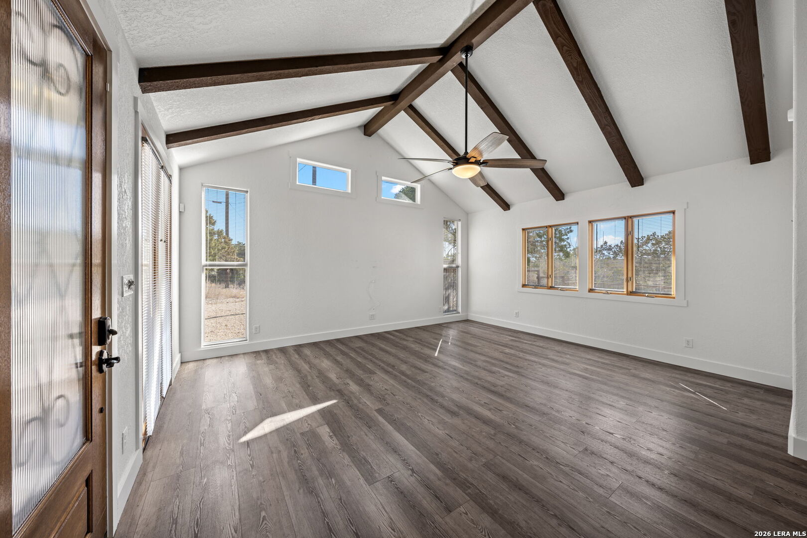 667 Ranch Rim Drive West Ingram, TX 78025 - Photo 11 of 50 wooden floor in an empty room with a window