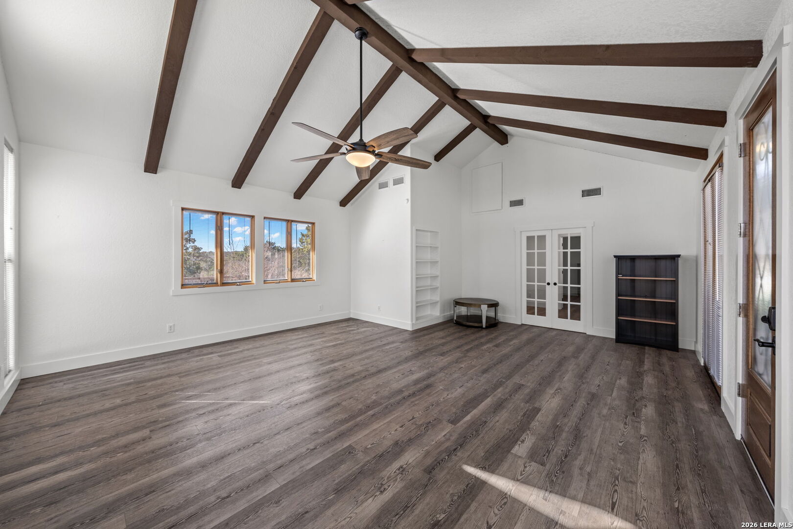667 Ranch Rim Drive West Ingram, TX 78025 - Photo 12 of 50 a view of empty room with wooden floor and fireplace