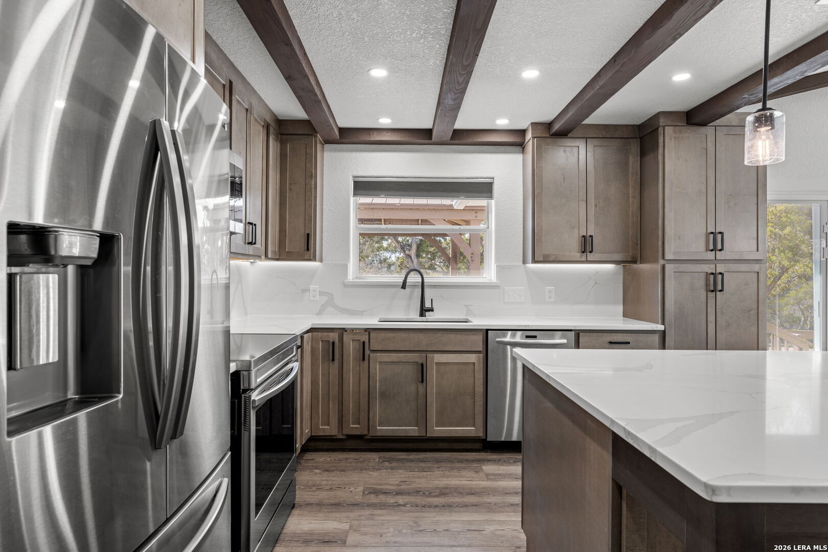 667 Ranch Rim Drive West Ingram, TX 78025 - Photo 14 of 50 a kitchen with a sink stainless steel appliances and cabinets
