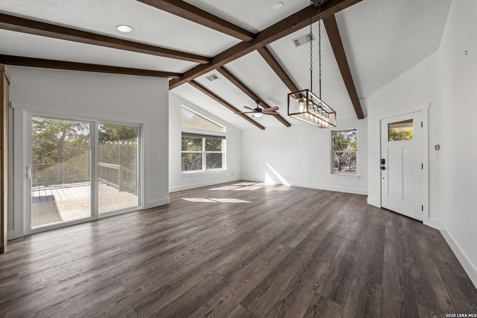 667 Ranch Rim Drive West Ingram, TX 78025 - Photo 16 of 50 a view of empty room with wooden floor and fan