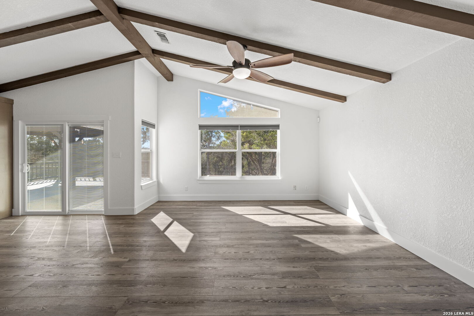 667 Ranch Rim Drive West Ingram, TX 78025 - Photo 19 of 50 a view of an empty room with wooden floor and a window