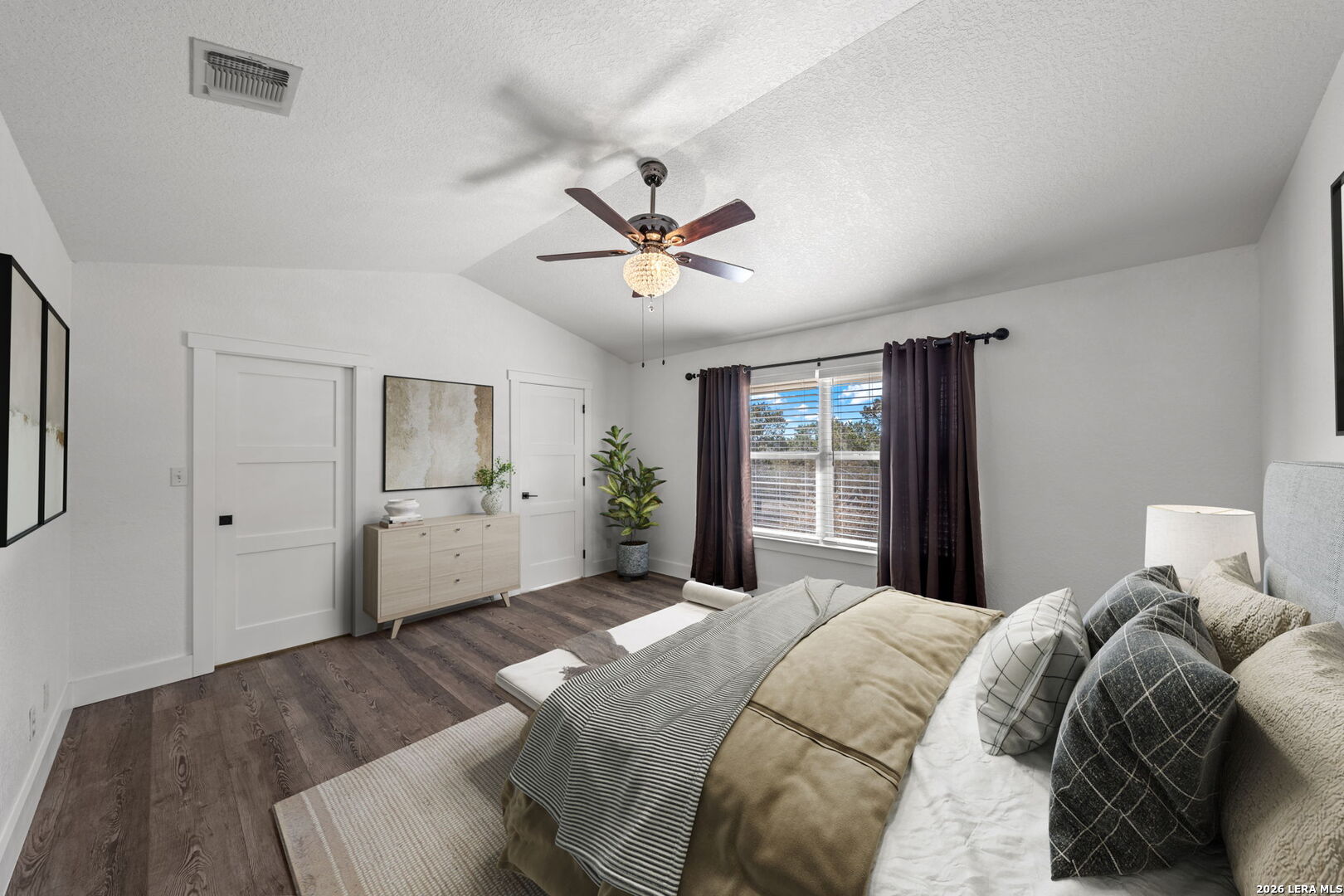 667 Ranch Rim Drive West Ingram, TX 78025 - Photo 20 of 50 a bedroom with a large bed and a chandelier