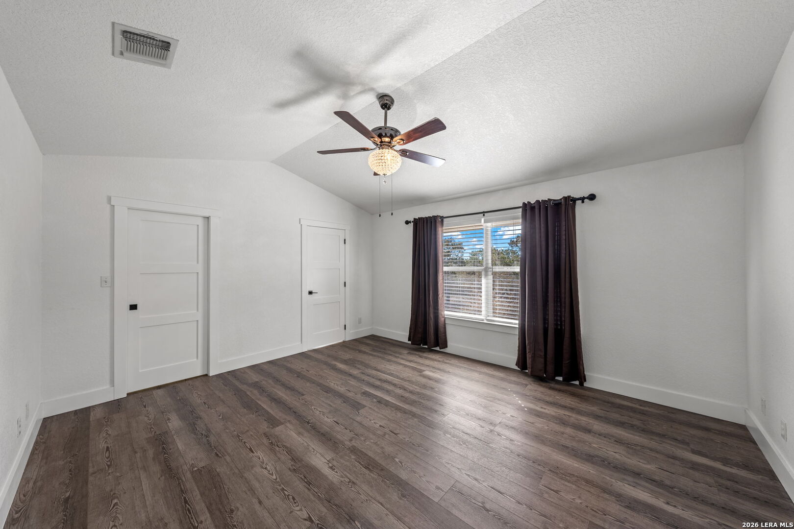 667 Ranch Rim Drive West Ingram, TX 78025 - Photo 21 of 50 wooden floor in an empty room with a window