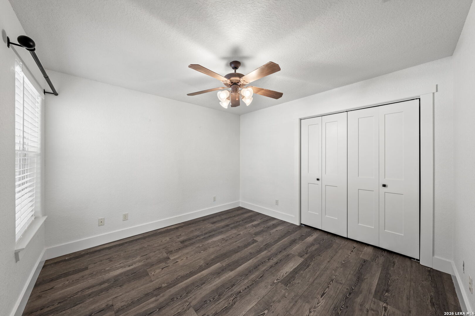 667 Ranch Rim Drive West Ingram, TX 78025 - Photo 25 of 50 wooden floor in an empty room with a window