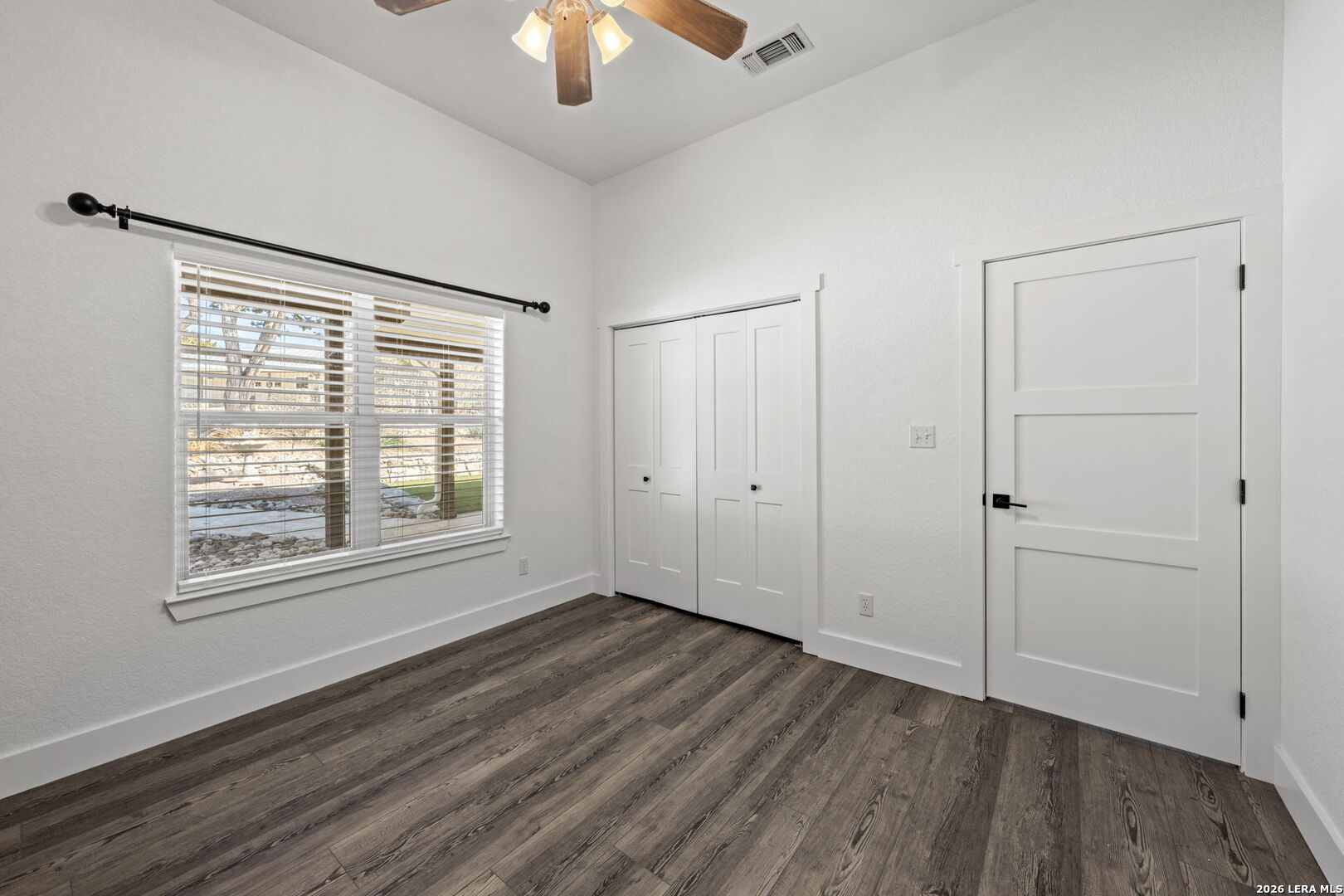 667 Ranch Rim Drive West Ingram, TX 78025 - Photo 28 of 50 a view of an empty room with wooden floor and a window
