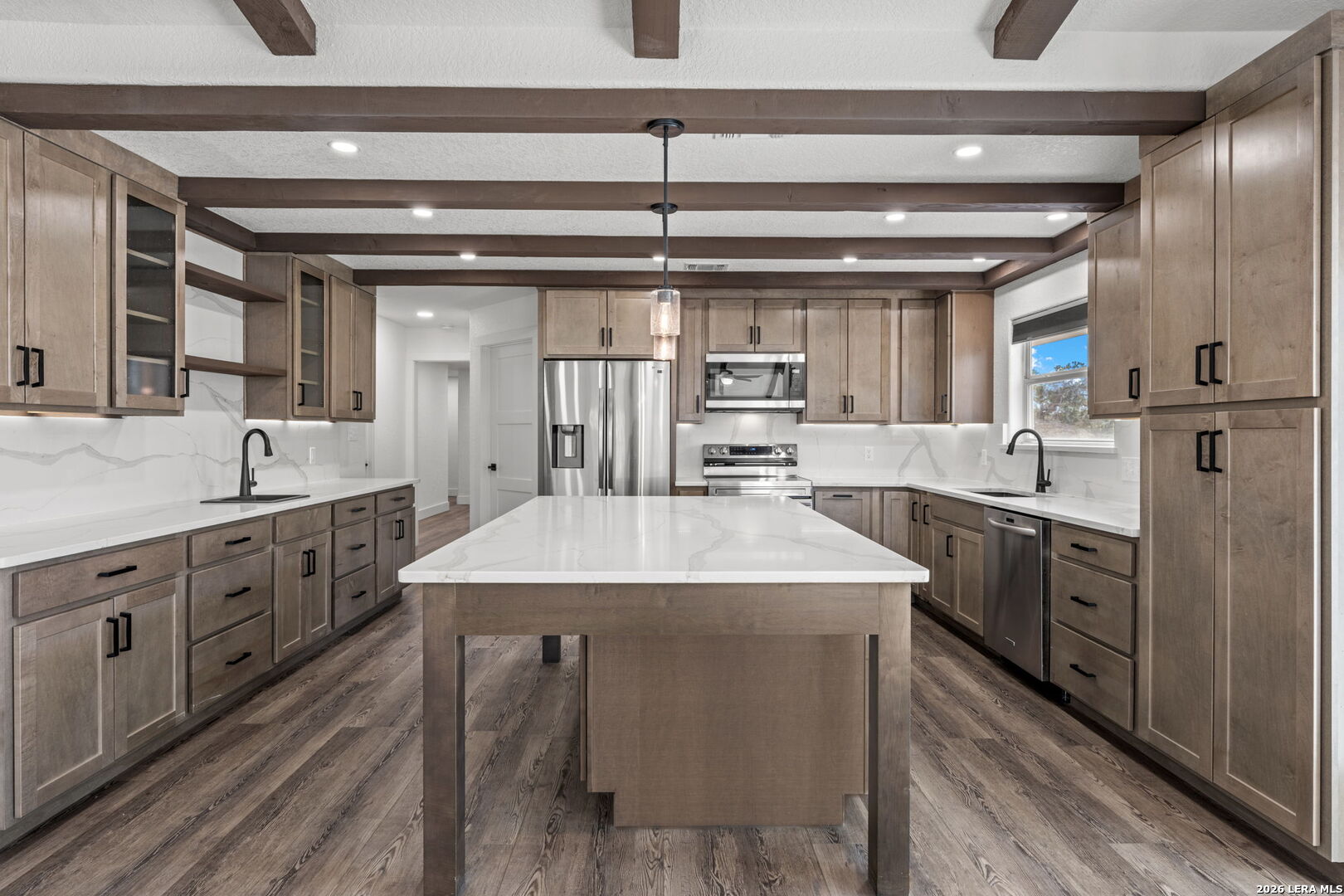 667 Ranch Rim Drive West Ingram, TX 78025 - Photo 3 of 50 a kitchen with stainless steel appliances kitchen island granite countertop a sink a stove and cabinets
