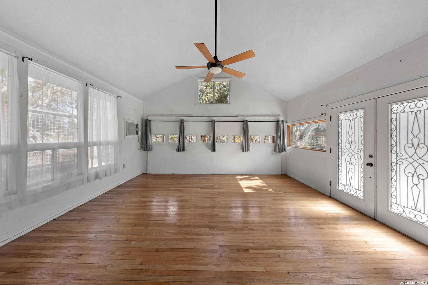 667 Ranch Rim Drive West Ingram, TX 78025 - Photo 36 of 50 a view of an empty room with a window and wooden floor