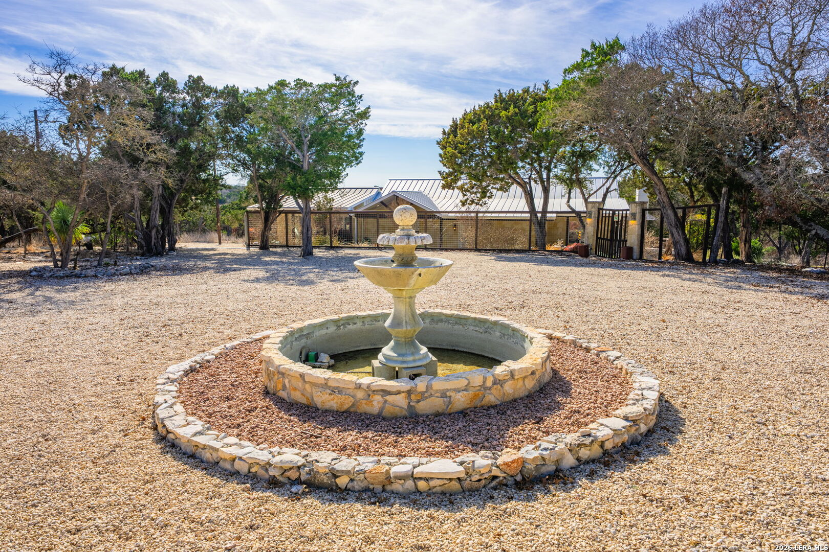 667 Ranch Rim Drive West Ingram, TX 78025 - Photo 45 of 50 a view of a water fountain in the middle of a yard