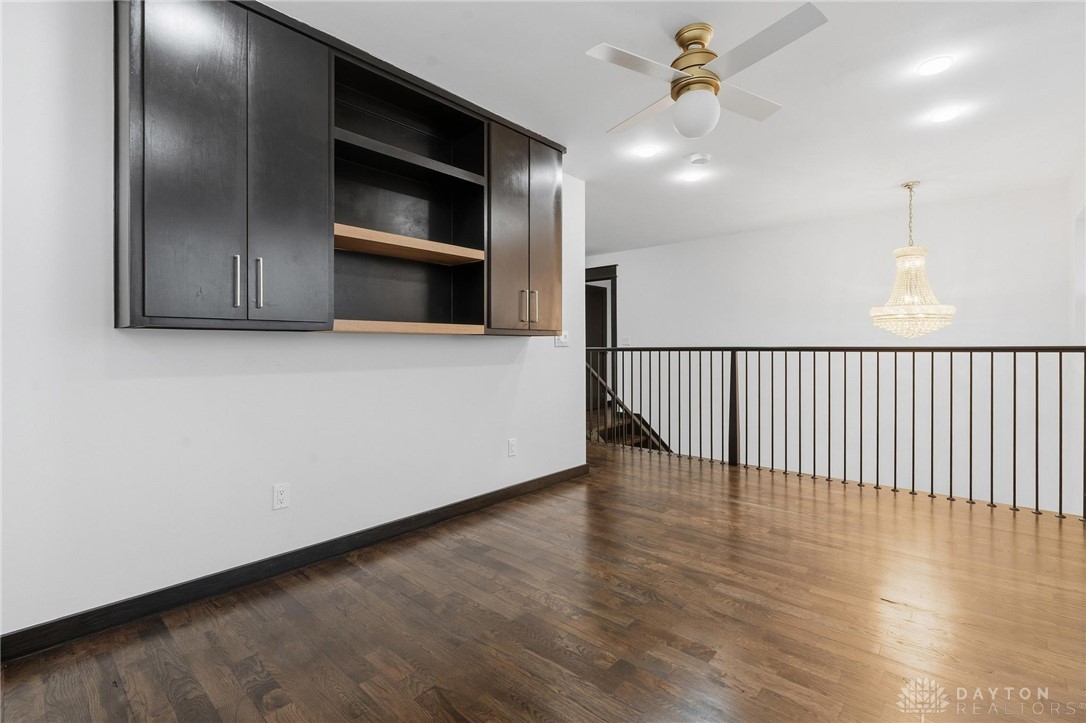 3509 South State Rte 72 Sabina, OH 45169 - Photo 24 of 44 This versatile loft area features built-in cabinetry and warm hardwood flooring, ideal for flexible living.