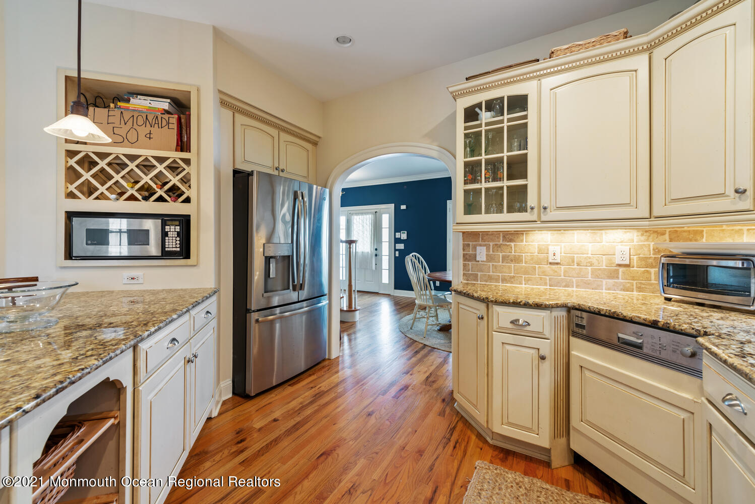 104 3rd Avenue Bradley Beach, NJ 07720 - Photo 12 of 40 a kitchen with stainless steel appliances granite countertop a refrigerator and wooden cabinets