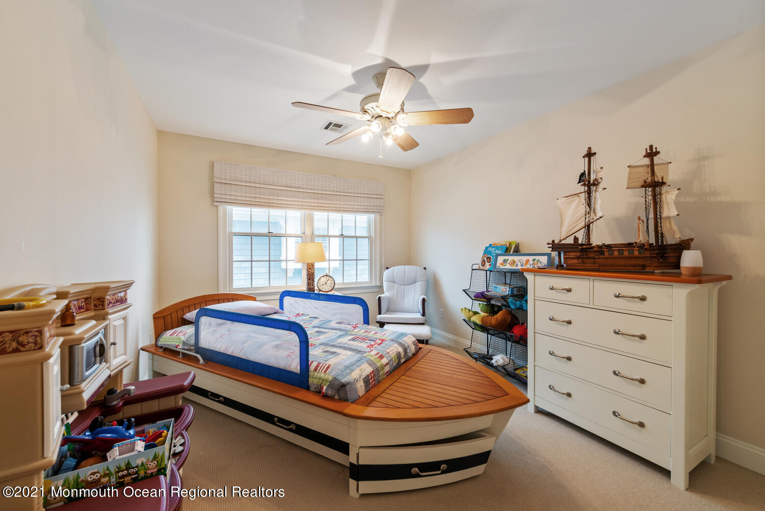 104 3rd Avenue Bradley Beach, NJ 07720 - Photo 23 of 40 a bedroom with a bed and a chandelier