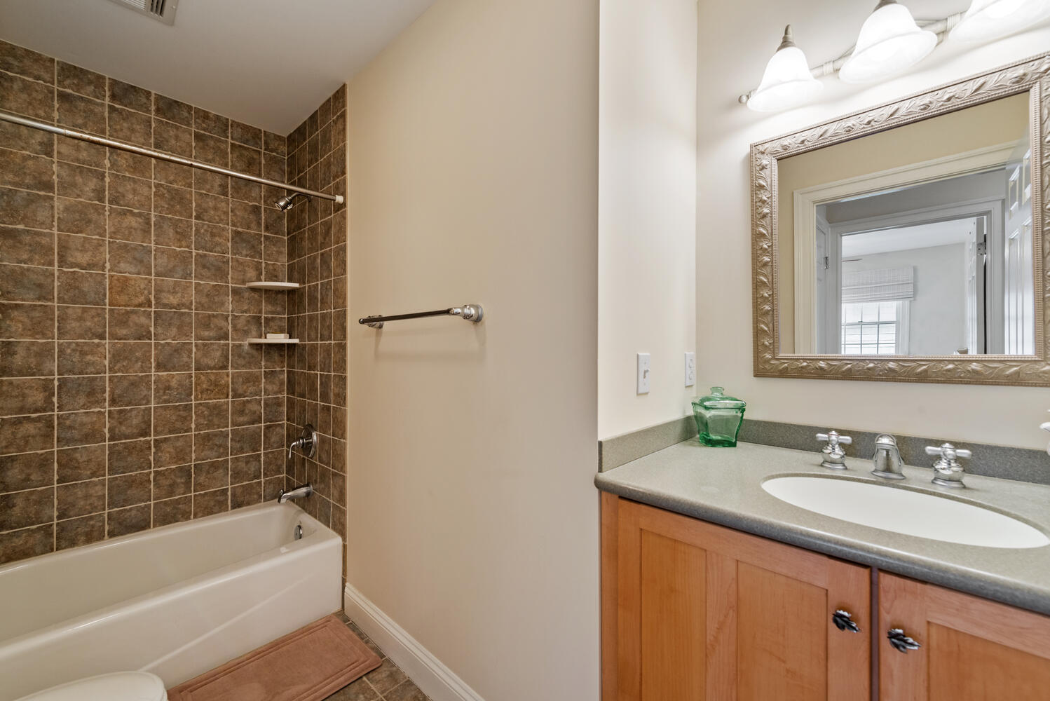 104 3rd Avenue Bradley Beach, NJ 07720 - Photo 29 of 40 a bathroom with a granite countertop sink a mirror a bathtub and shower