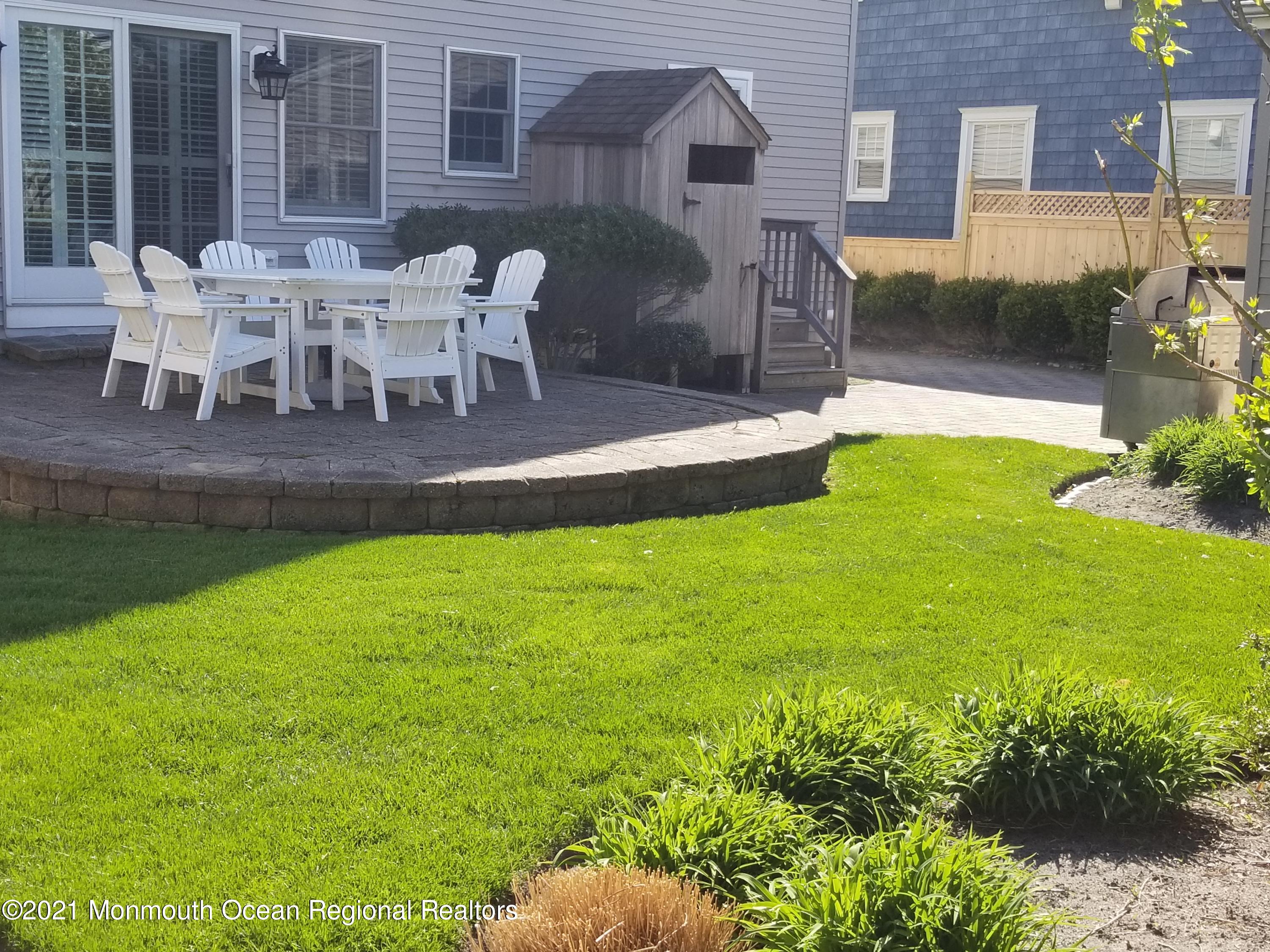 104 3rd Avenue Bradley Beach, NJ 07720 - Photo 35 of 40 a view of a patio with table and chairs and potted plants