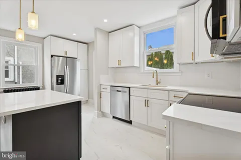 a kitchen with a sink cabinets and stainless steel appliances